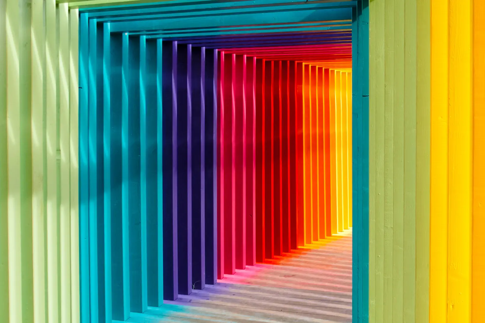 Coloured panels arranged in a receding corridor of graduated hues