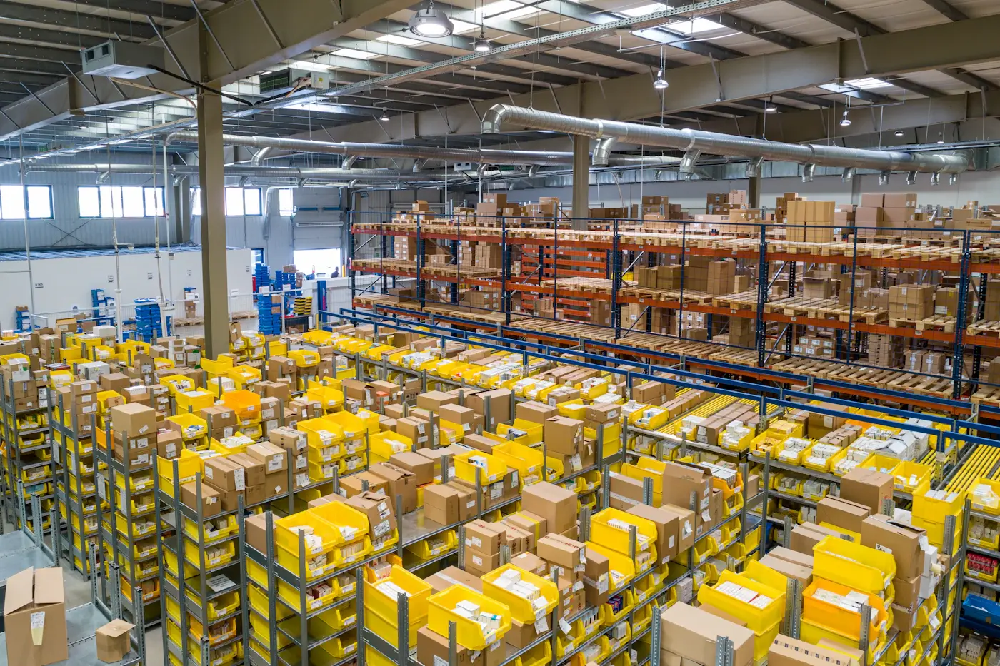 A fulfilment warehouse with racking and stacked shipping cartons